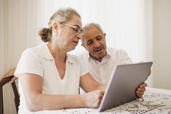 Couple on tablet sitting at table
