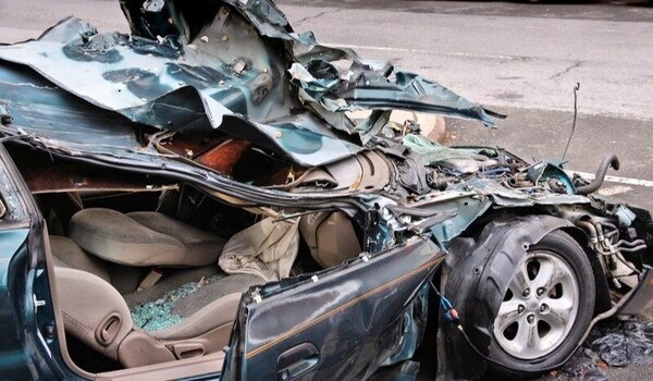 car with severe damage from collision with crushed hood, roof, and interior-1
