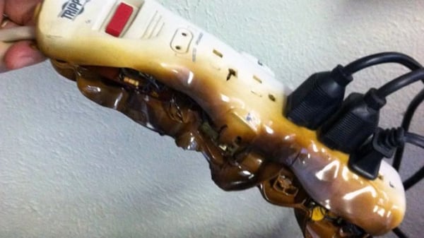 hand holding melted power strip
