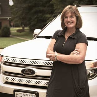 happy mom in front of car