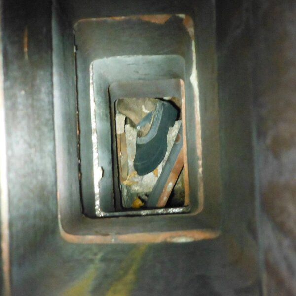 looking down chimney vent at mans boot-1