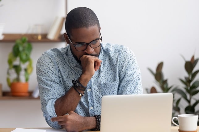 man looking at computer with concern