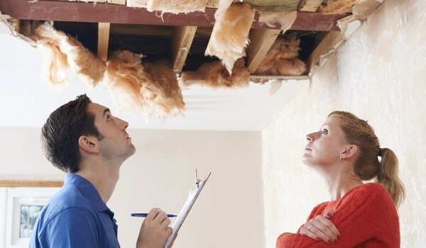 woman getting estimate for home storm damage-1