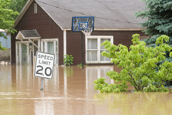 Flooded-rural-home-with-basketball-hoop-and-speed-limit-sign-v2